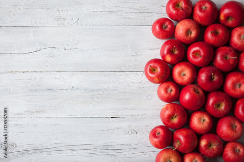 Red apples on a wooden background