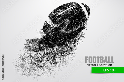 Hand holds the rugby ball, silhouette from particles