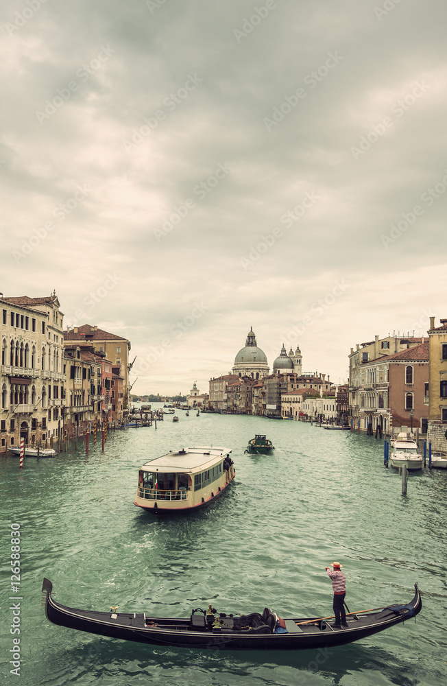 View of gondola and boats on Canal Grande at a cloudy day, Venice (Venezia), Italy, Europe, Vintage filtered style