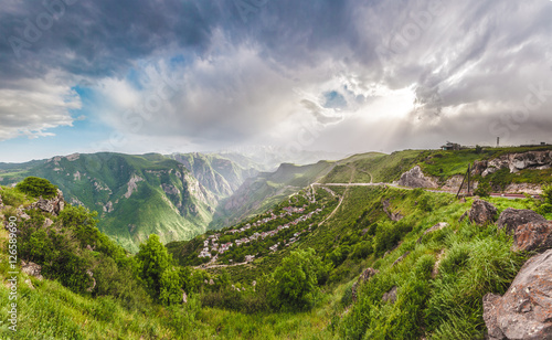 Beautiful landscape with green mountains and magnificent cloudy sky in sunset. Exploring Armenia