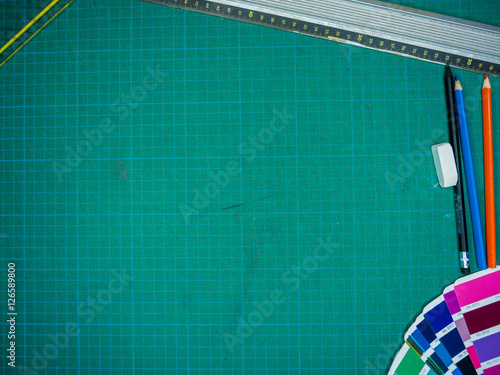 Cutting mat with various stationary tools, shot from above