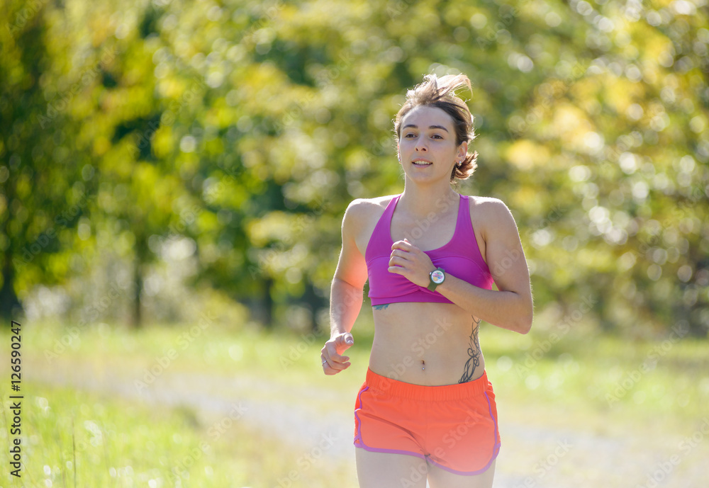 Beautiful athletic woman running in countryside Beautiful athletic woman running in countryside