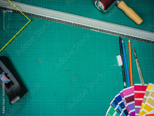 Cutting mat with various stationary tools, shot from above