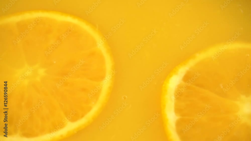 Sliced orange falling into orange juice Sliced orange falling into orange juice
