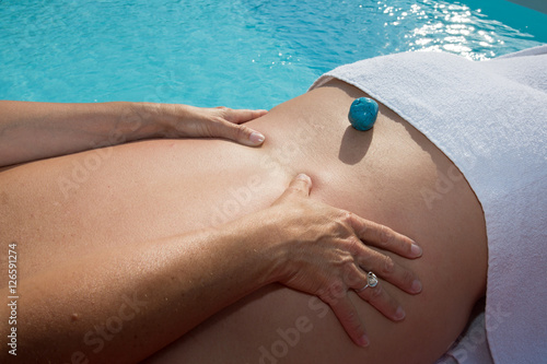 Peaceful man getting reiki treatment poolside outside at the spa photo