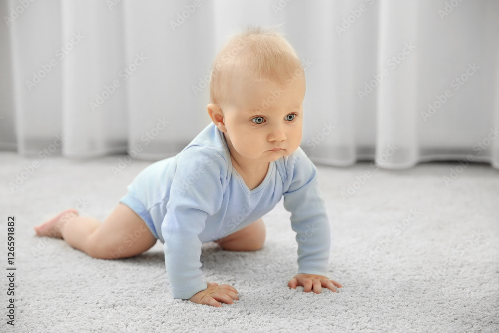 Adorable little baby crawling on light carpet Adorable little baby crawling on light carpet