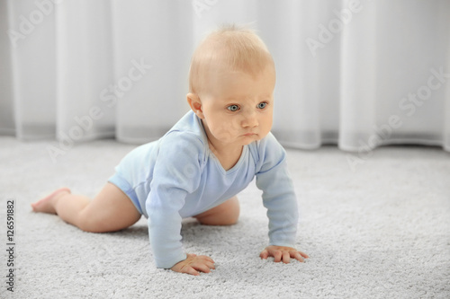 Adorable little baby crawli...