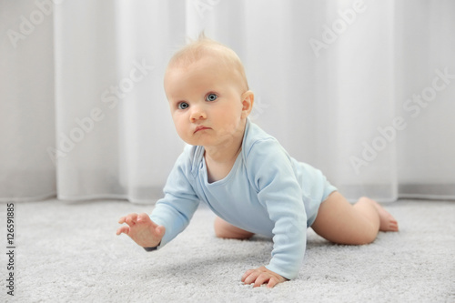 Adorable little baby crawli...