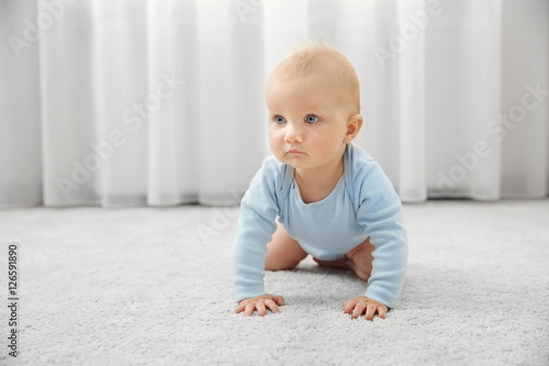 Adorable little baby crawli...