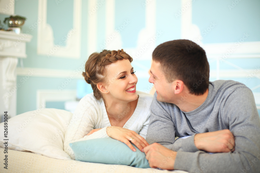 Happy couple on the sofa bed in the living room. Happy couple on the sofa bed in the living room.