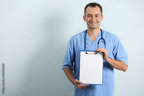 Doctor with clipboard on li...