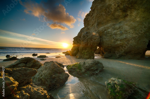 Last Light as sun sets behind the cliffs at El Matador State Beach near Malibu California photo