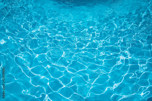 Beautiful ripple water in swimming pool witn sun reflection