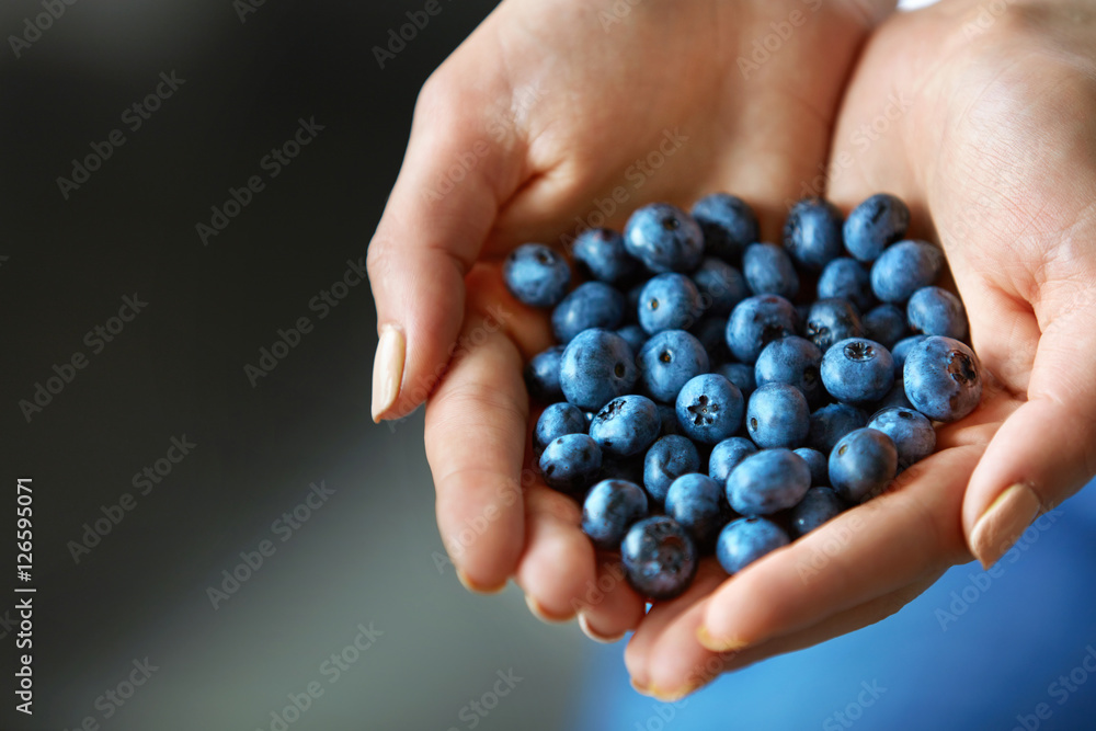 Healthy Organic Food. Woman Hands Full Of Fresh Ripe Blueberries