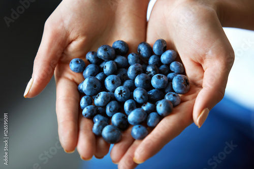 Healthy Organic Food. Woman Hands Full Of Fresh Ripe Blueberries