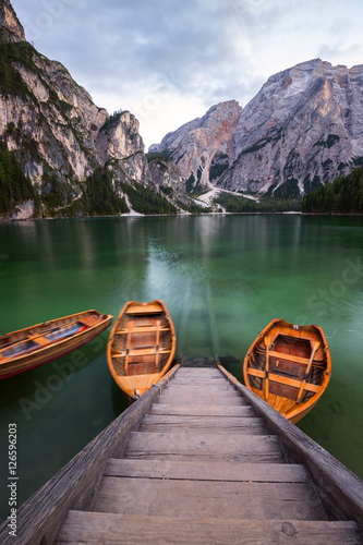 Boats on the Braies Lake ( Pragser Wildsee ) in Dolomites mounta