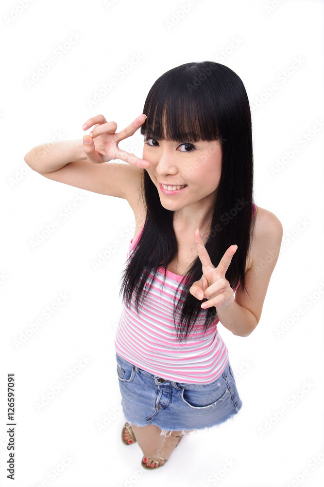 Young woman making peace sign, smiling Young woman making peace sign, smiling