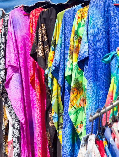 Clothing and fabrics in street market stall