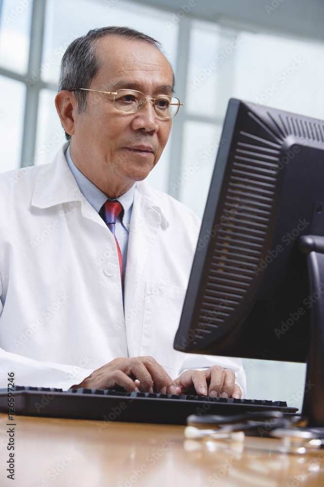 Doctor using desktop computer