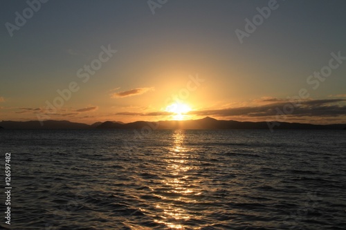 Sunrise over the Whitsunday Islands QLD Australia with reflections of the sun on the water