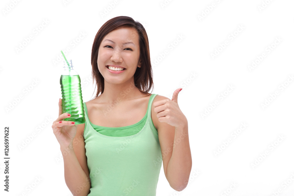 Young woman holding bottled drink, making thumbs up sign Young woman holding bottled drink, making thumbs up sign