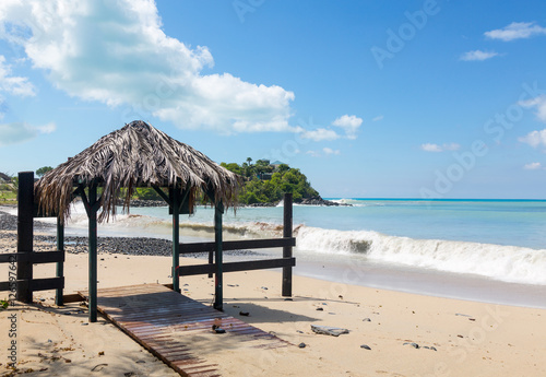 Table and chairs covered by sand on beach