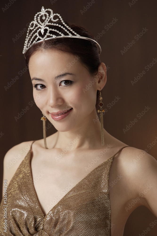 portrait of woman wearing crown, smiling at camera