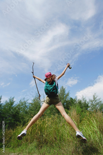 Female hiker  jumping  arms outstretched