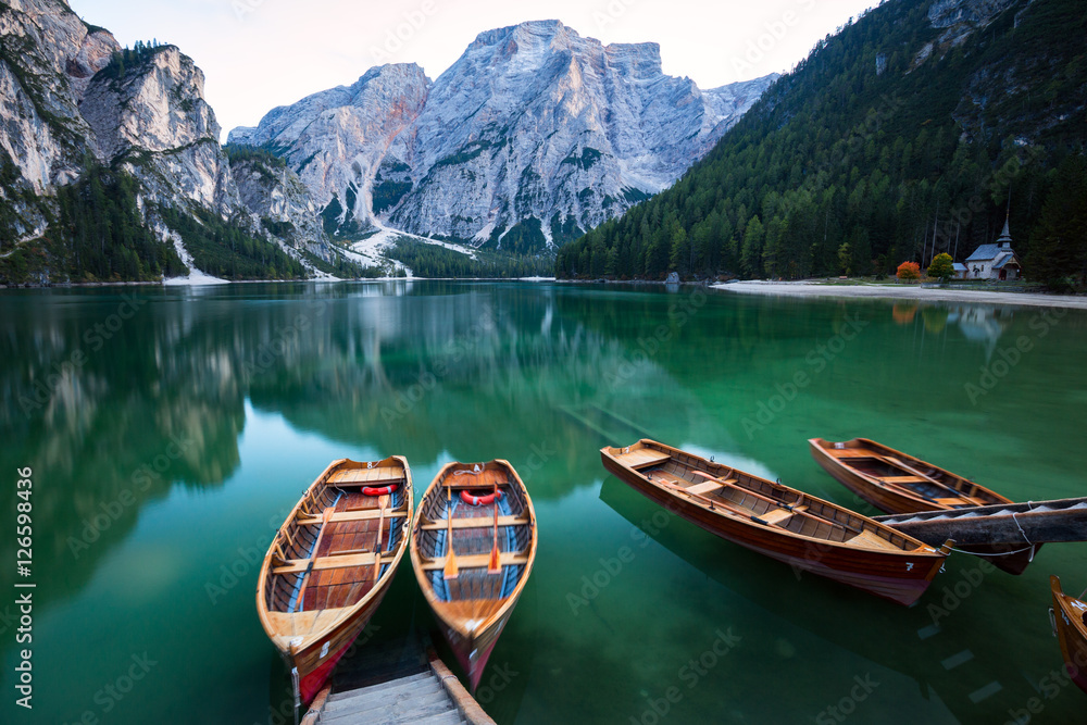 Boats on the Braies Lake ( Pragser Wildsee ) in Dolomites mounta