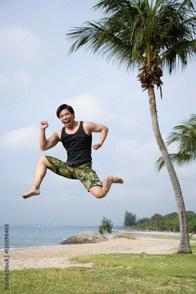 Man jumping in air, looking at camera Man jumping in air, looking at camera