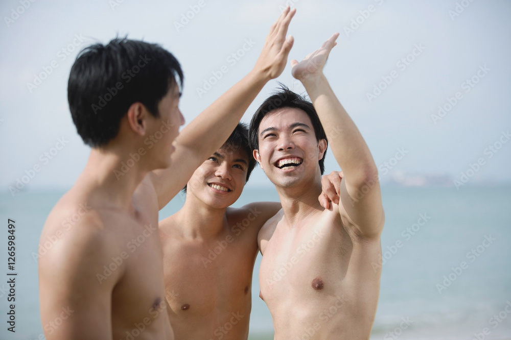 Three men together, giving high fives Three men together, giving high fives
