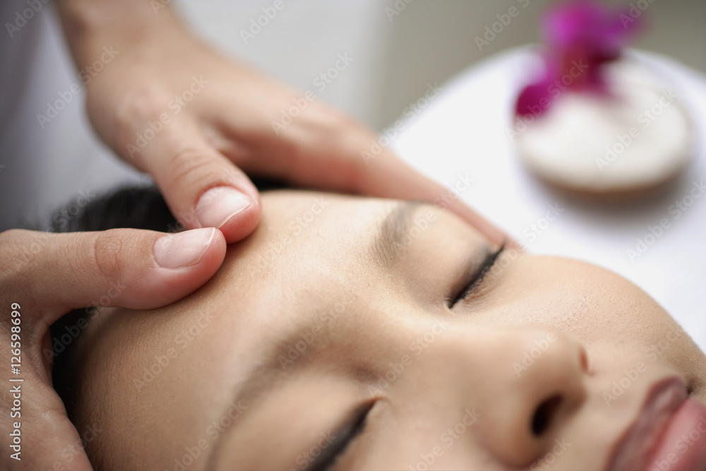 Young woman receiving head massage Young woman receiving head massage