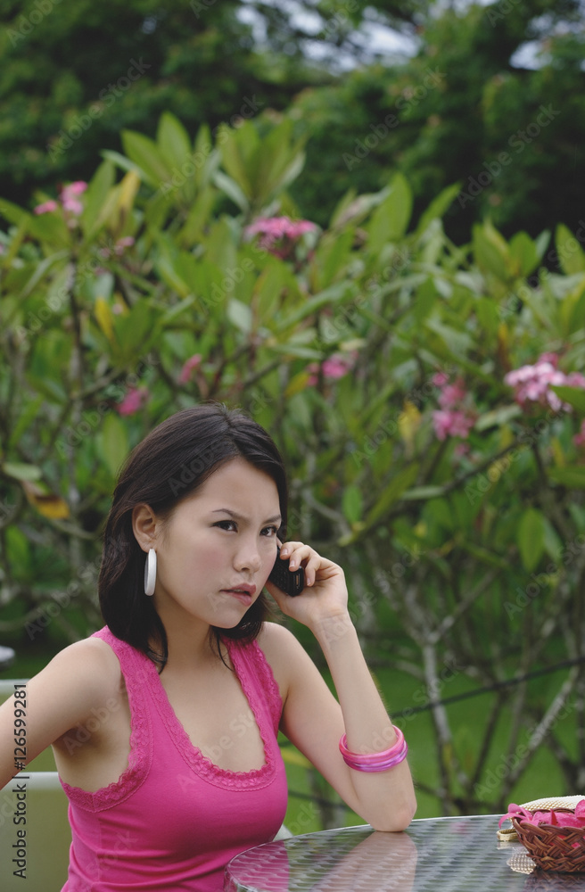 Young woman the phone, angry expression on face Young woman the phone, angry expression on face