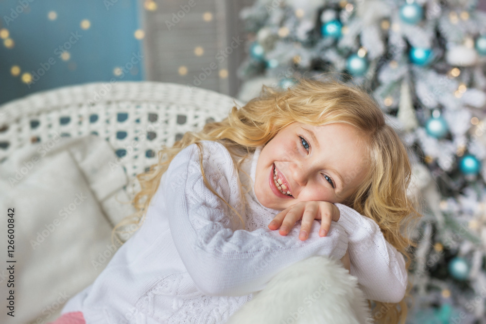 Portrait of smiling little on a chair in Christmas time Portrait of smiling little on a chair in Christmas time