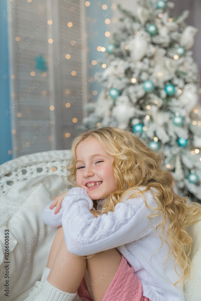 Portrait of very smiling little girl on a chair in Christmas time Portrait of very smiling little girl on a chair in Christmas time