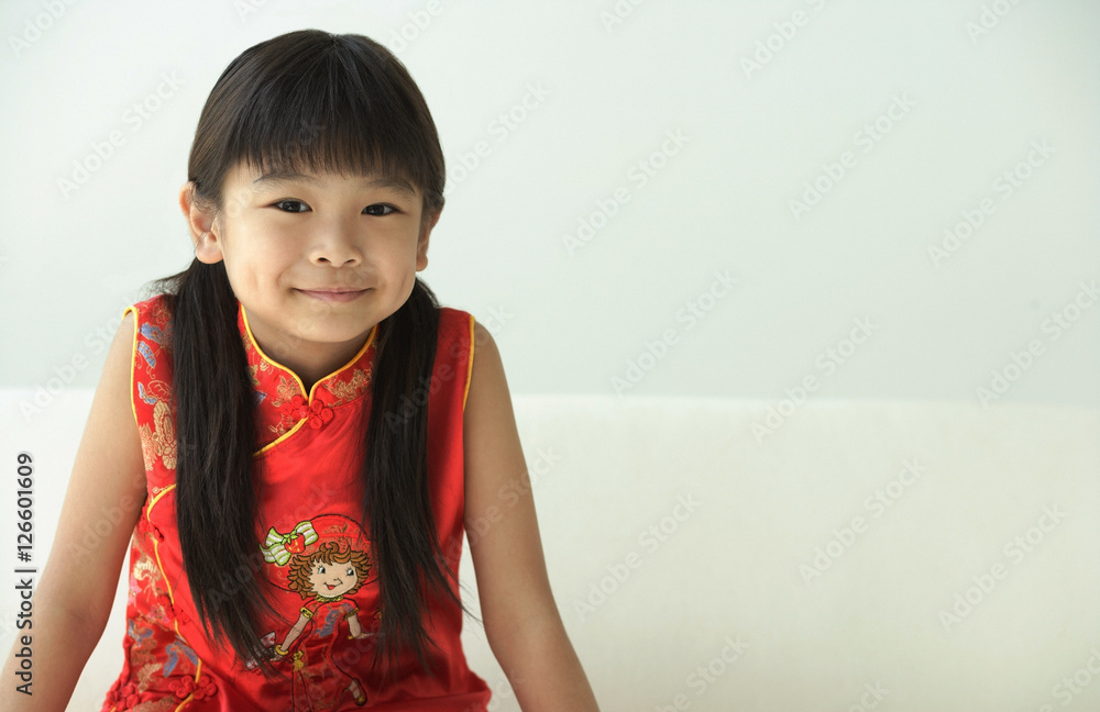 Girl in traditional clothes smiling at camera
