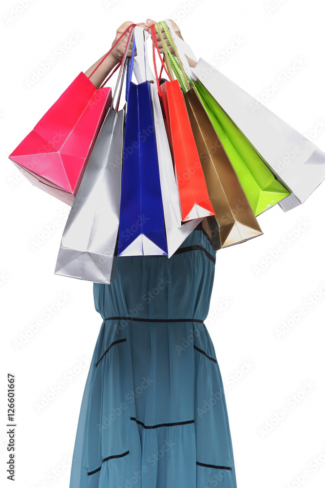 Young woman holding shopping bags in front of face