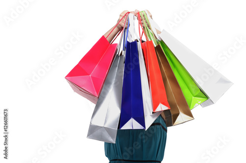 Young woman holding shopping bags in front of face