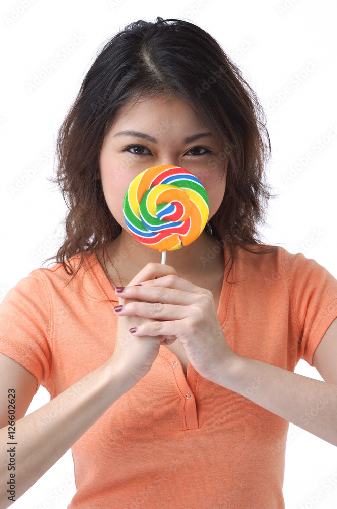 Young woman with lollipop looking at camera