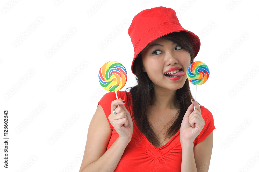 Young woman licking on lollipop