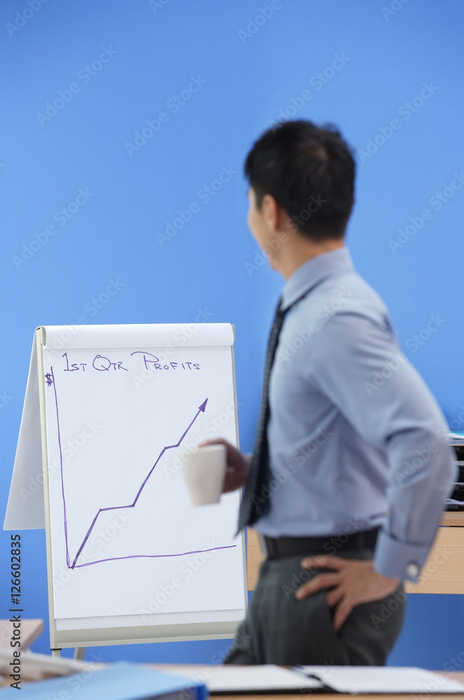 Businessman looking at statistics Businessman looking at statistics