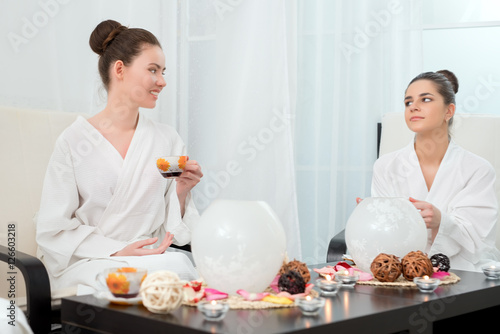 Image of lovely girls drinking tea in beauty salon