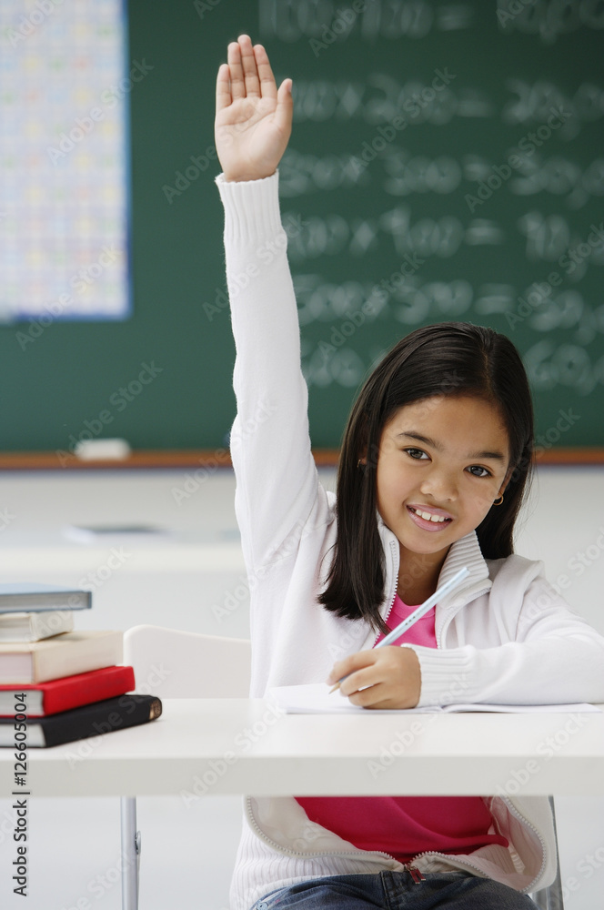 Girl raising hand in class