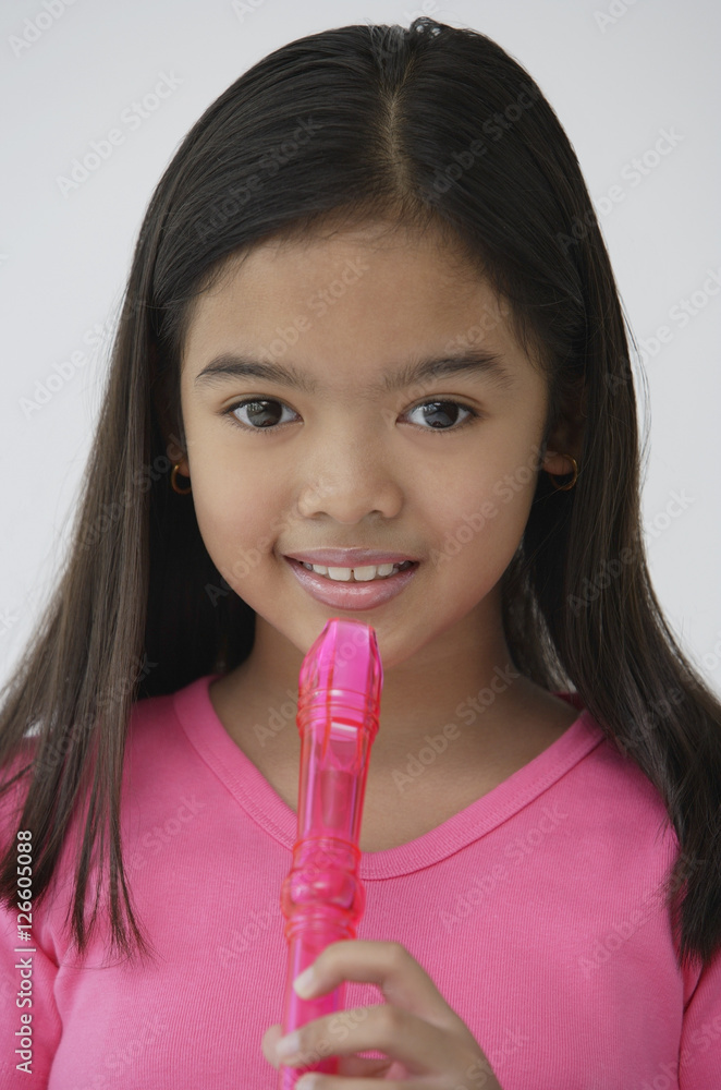 Girl with pink recorder, looking at camera Girl with pink recorder, looking at camera