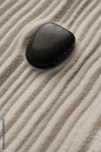 closeup of zen garden pebble detail on raked sand
