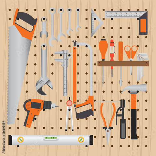 Repair and construction working tools on peg wooden background.