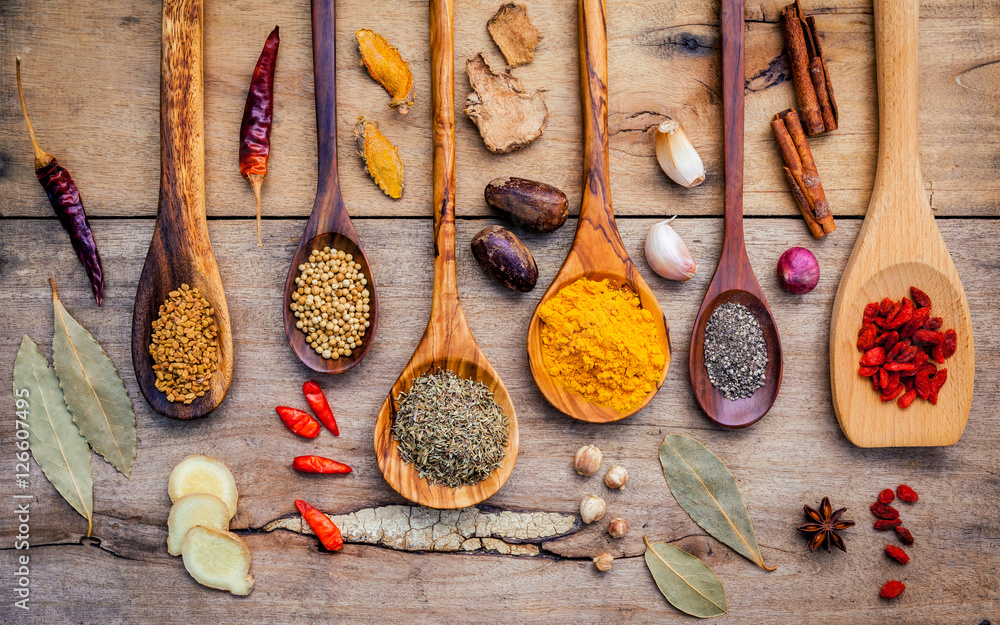 Various herbs and spices in wooden spoons. Flat lay of spices in - obrazy, fototapety, plakaty 