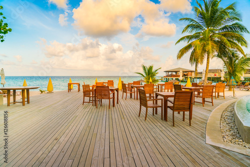 Table and chairs at restaurant in tropical Maldives island .