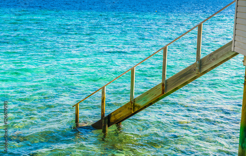 Wood stair into the sea of tropical Maldives island