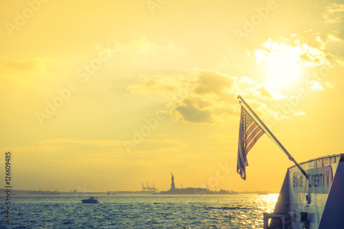 American flag with Statue of Liberty, New York City , USA .  ( F © jannoon028